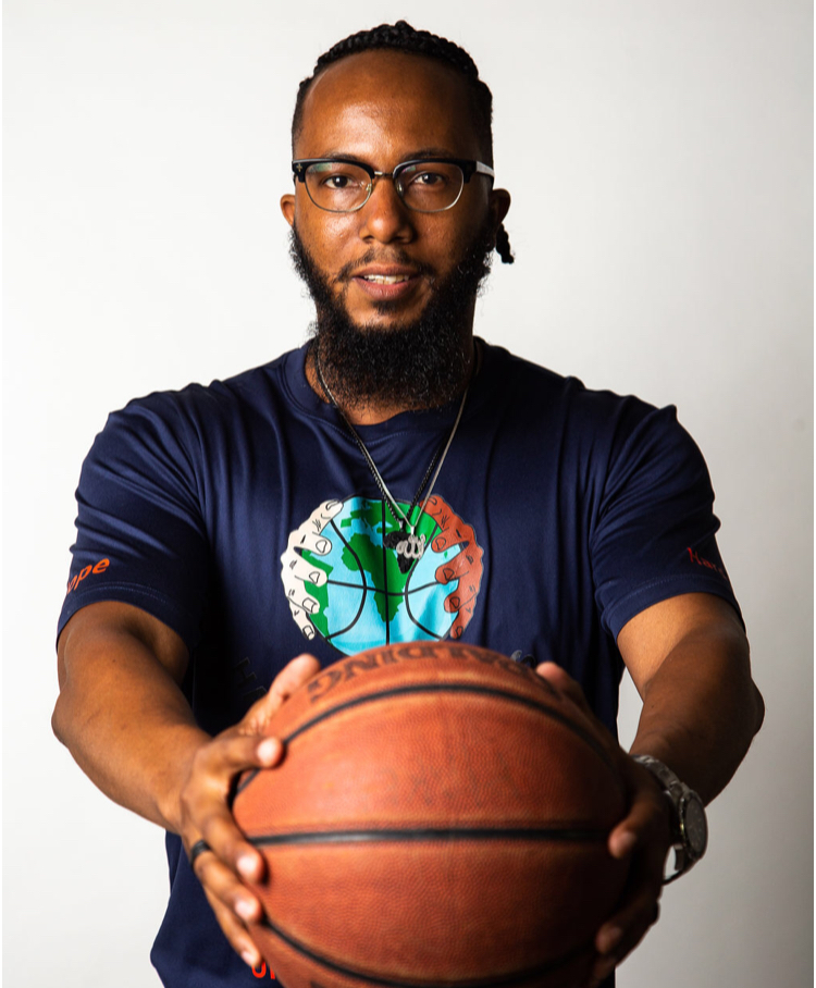 Photo of Hakeem holding a basketball. 